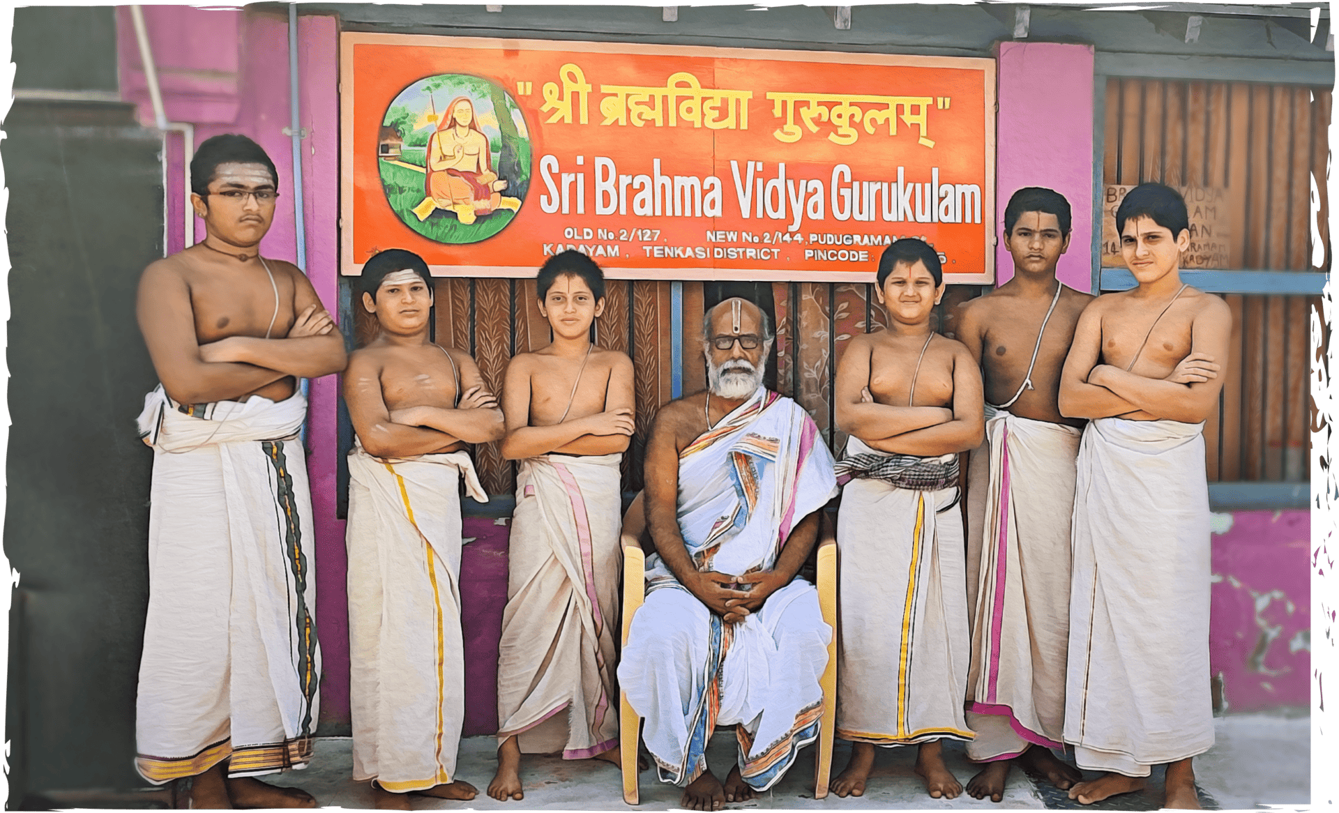 Image of Vedic students with their guru in front of the Gurukulam.