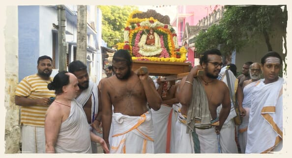 A group of Vedic priests in a chariot procession.